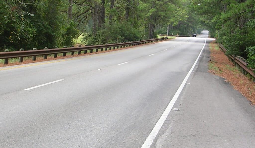 GSI Highway Guardrail Category Image of a weathered metal beam guardrail fence