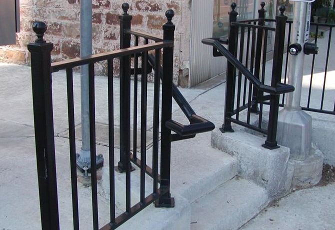 Custom steel handrail near steps on the sidewalk