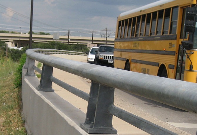 GSI Highway Elliptical Products Category Image of a bridge rail with school bus in background